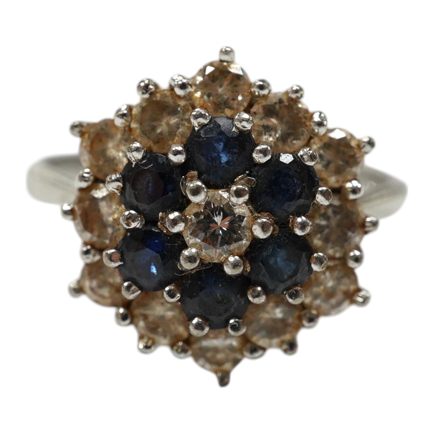 An 18ct white metal, sapphire and diamond set cluster ring, size O, gross weight 4.1 grams. Condition - fair to good